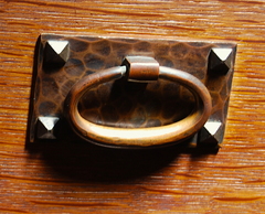 Close up hand hammered copper hardware in original patina.